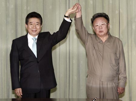 Top leader of the Democratic People's Republic of Korea (DPRK) Kim Jong Il (R) and South Korean President Roh Moo-hyun pose after they exchanged the document in Pyongyang, capital of DPRK, Oct. 4, 2007. The Declaration for the Development of Inter-Korean Relations, Peace and Prosperity was signed at the Paekhawon State Guesthouse at 1:00 p.m.(0400 GMT), said the news release. 