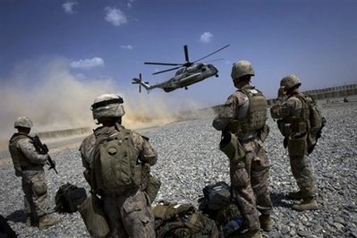US Marines wait to board a CH-53 helicopter as it lands in Helmand ...