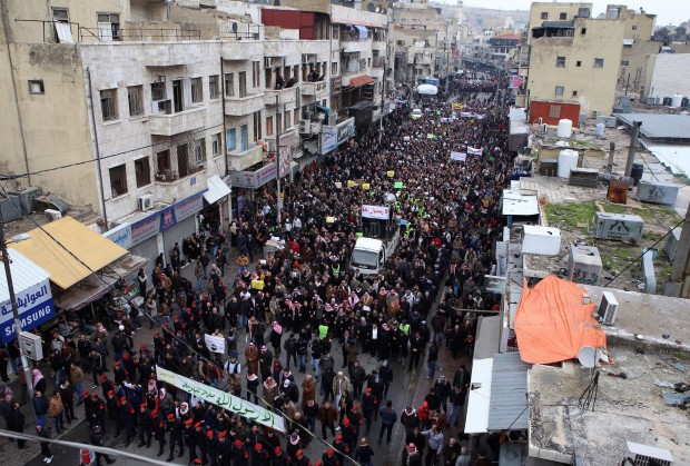 Jordanians gather to protest against cartoons depicting the Prophet Muhammad in the French satirical magazine Charlie Hebdo, after Friday prayers in Amman, Friday, Jan. 16, 2015. A rally by Pakistani students against a French satirical weekly's latest publication of a Prophet Muhammad cartoon turned violent on Friday, with police firing warning shots and water cannons to disperse the demonstration. A photographer with the Agence France-Presse was shot and wounded in the melee. But although there were concerns that rallies against Charlie Hebdo' new cover depicting the prophet  an act deemed insulting to many followers of Islam  would unravel into violence across the Muslim world, most of the protests elsewhere passed peacefully. (AP Photo/Raad Adayleh)