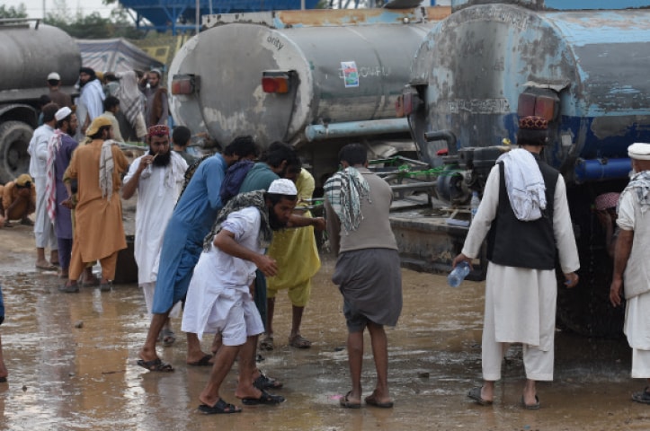 Water stands at the H-9 protest venue and the road adjacent to it. — Photos by Tanveer Shahzad and Kashif Abbasi